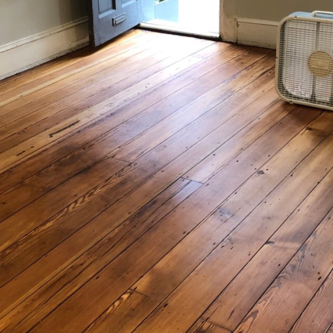 After: Floor Refinishing Project - Worn floors professionally refinished and restored